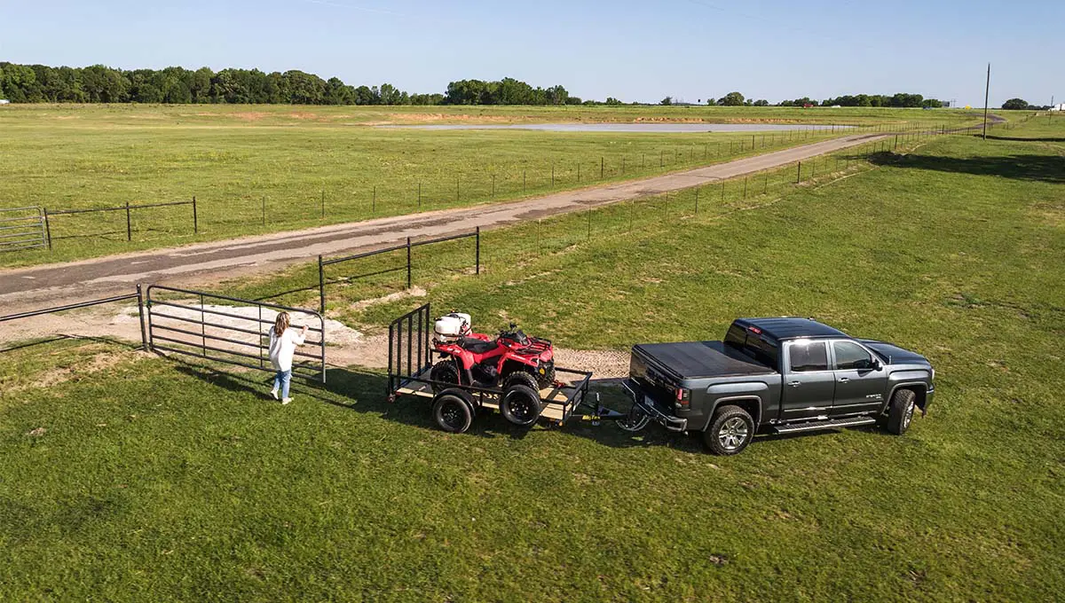 a truck is pulling a 30sa utility trailer with an atv on it