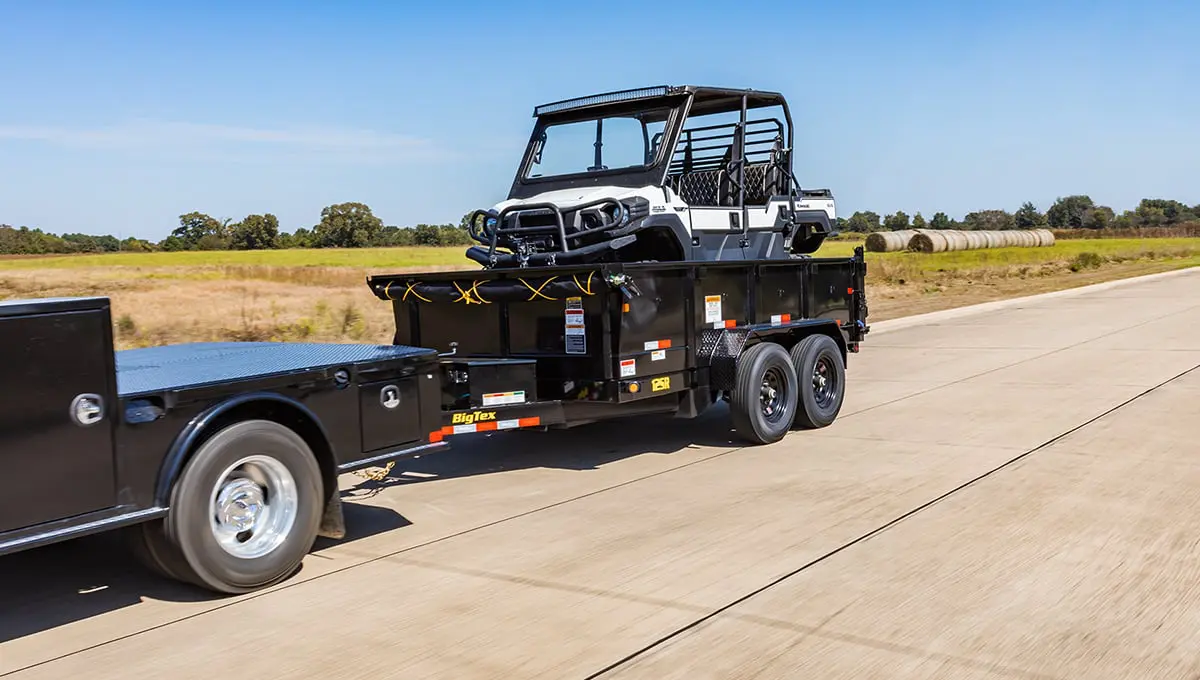 a 12sr dump trailer with a utility trailer attached to it