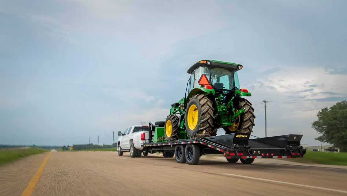 14GN gooseneck trailer carrying construction vehicle