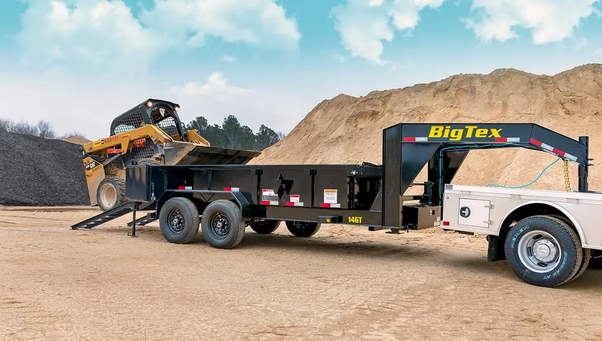 a 14GT commercial grade dump big tex trailer is being pulled by a white truck