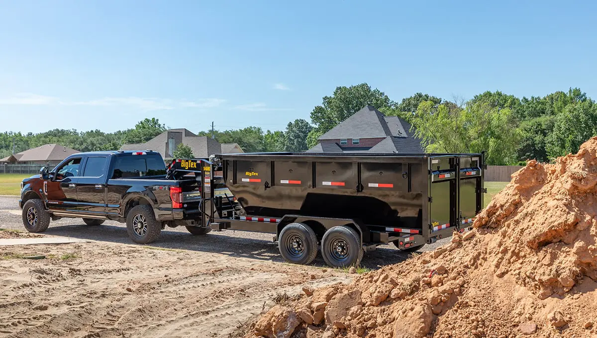 a 14rd dump trailer is being pulled by a ford truck