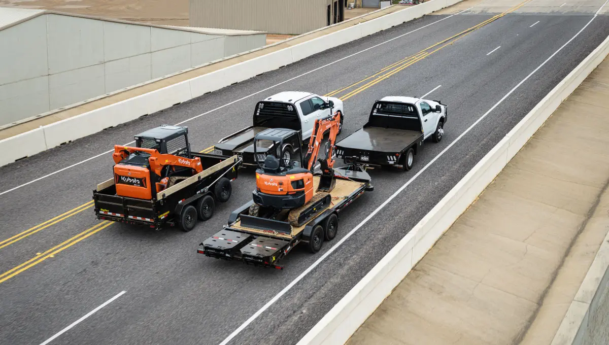 a kubota excavator is on the back of a truck