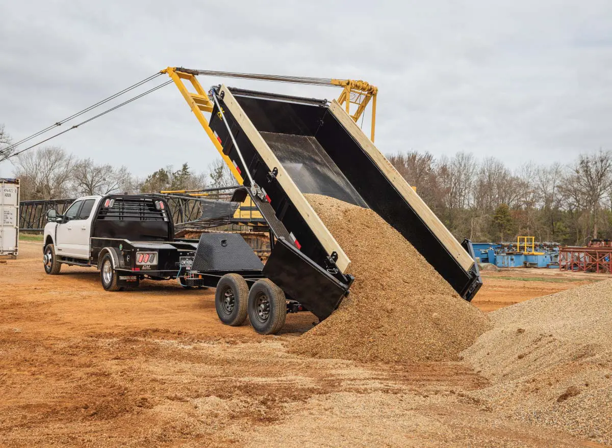 a scissor lift dump truck has a license plate that says jcw