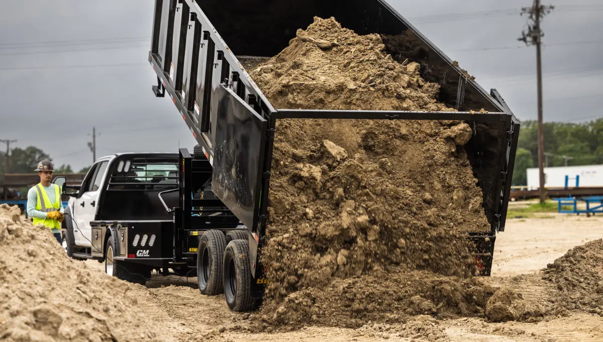 Man operating Big Tex Trailer Dump Trailer