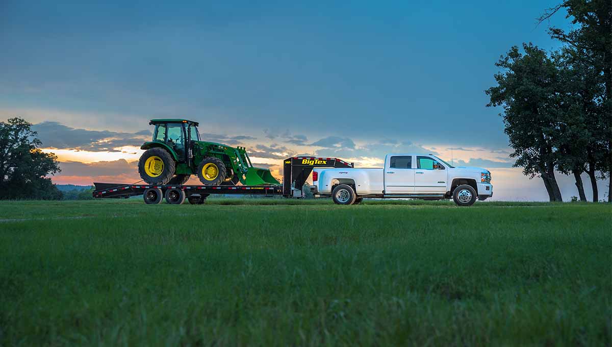 white truck and 14GN flatbed gooseneck trailer