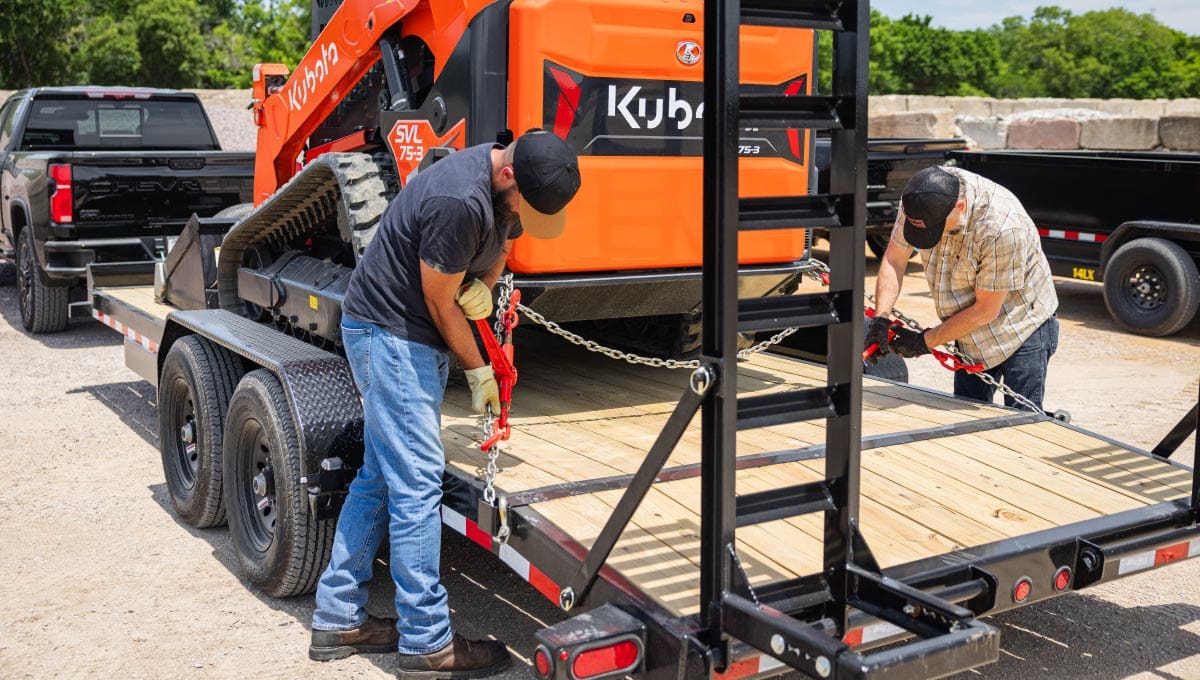 Two Men Securing Equipment on Big Tex 14EB Trailer